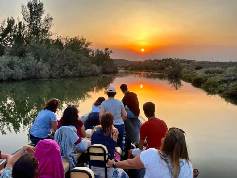 People on a boat on the Arade river close to silves enjoying a golden sunset