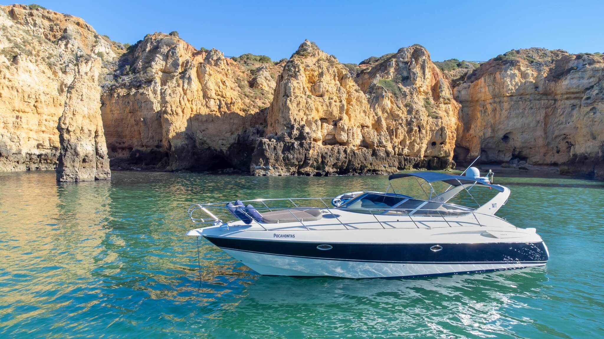 Stunning yacht in front of the gold cliffs of Lagos