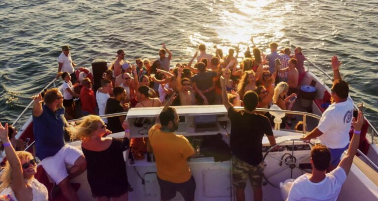 Group of people enjoying a party on a boat during sunset