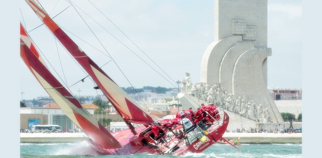 CAMPER with Emirates Team New Zealand passes Padrão dos Descobrimentos monument at the start of Leg eight from Lisbon, Portugal. Volvo Ocean race 2011-12. 10/6/2012