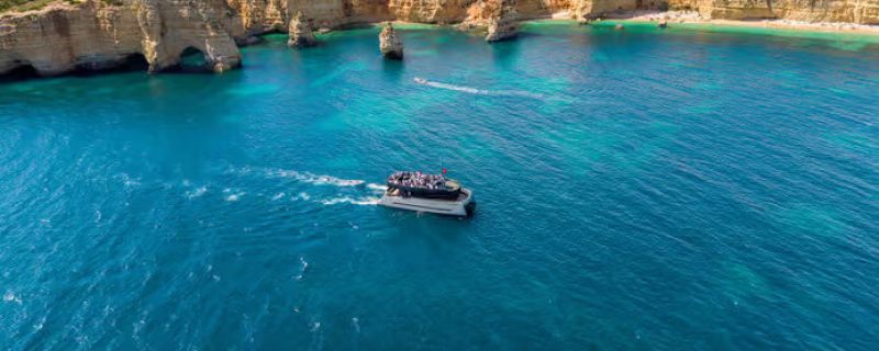 Modern catamaran cruising in Albufeira