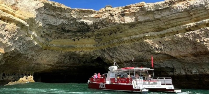 Veleiro catamarã a navegar em direção à Gruta de Benagil durante a época natalícia.