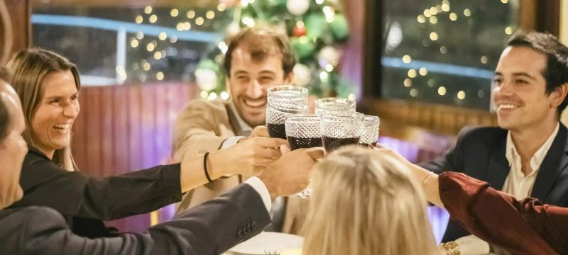 Guests enjoying a festive Christmas party with drinks and food on the historic EVORA boat in Lisbon